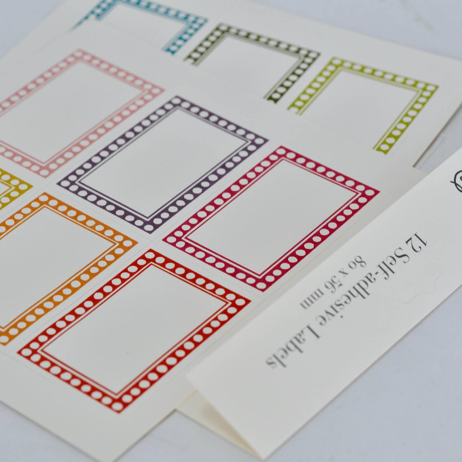 Colorful square labels on a white card with text