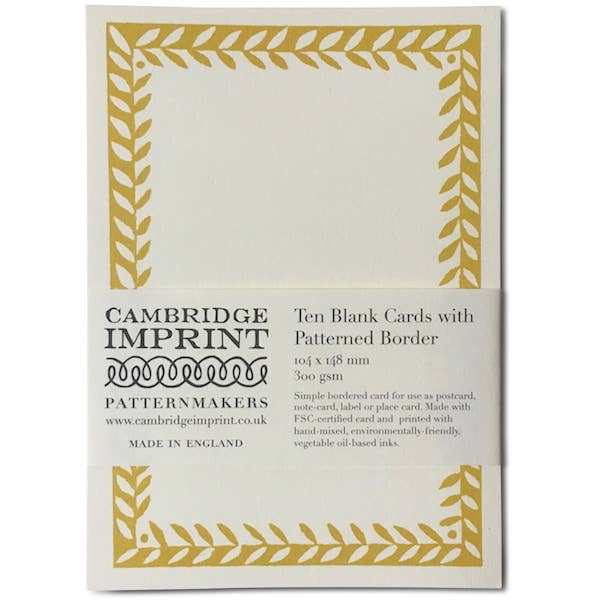 Pack of Cambridge Imprint blank cards with gold border on a white background