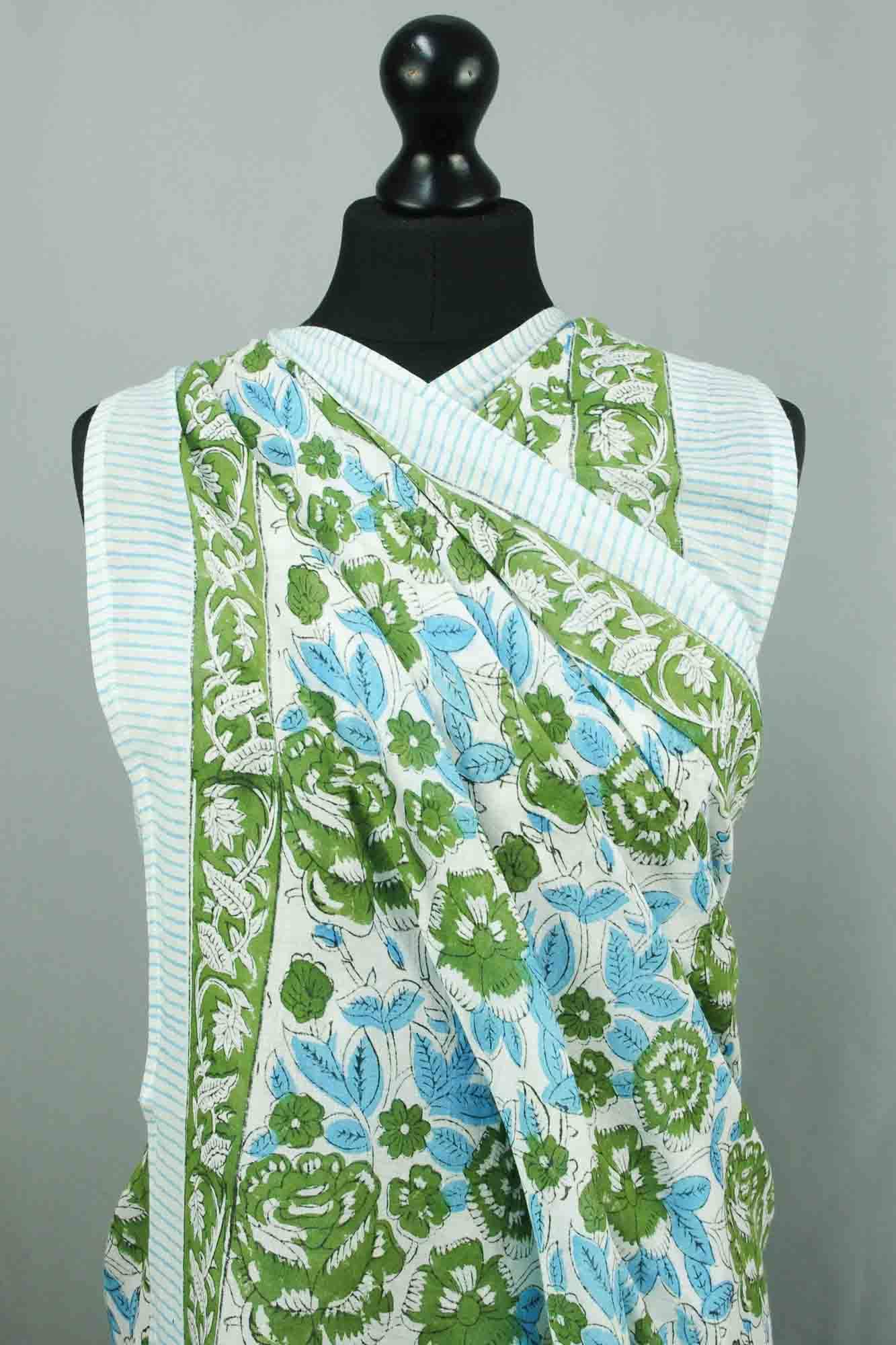 Mannequin wearing a light blue and green patterned garment against a gray background