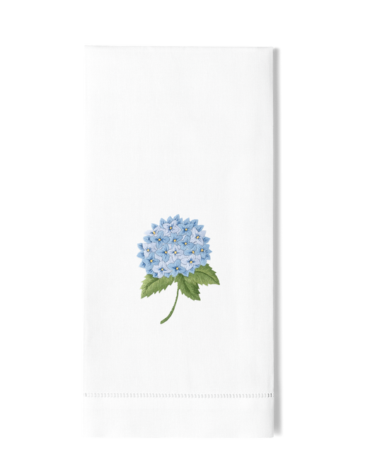 White towel with a blue flower design on a white background