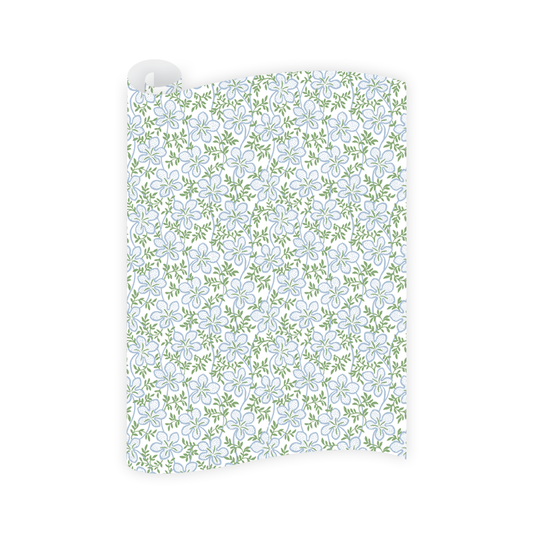 Floral patterned paper with blue flowers and green leaves on a white background