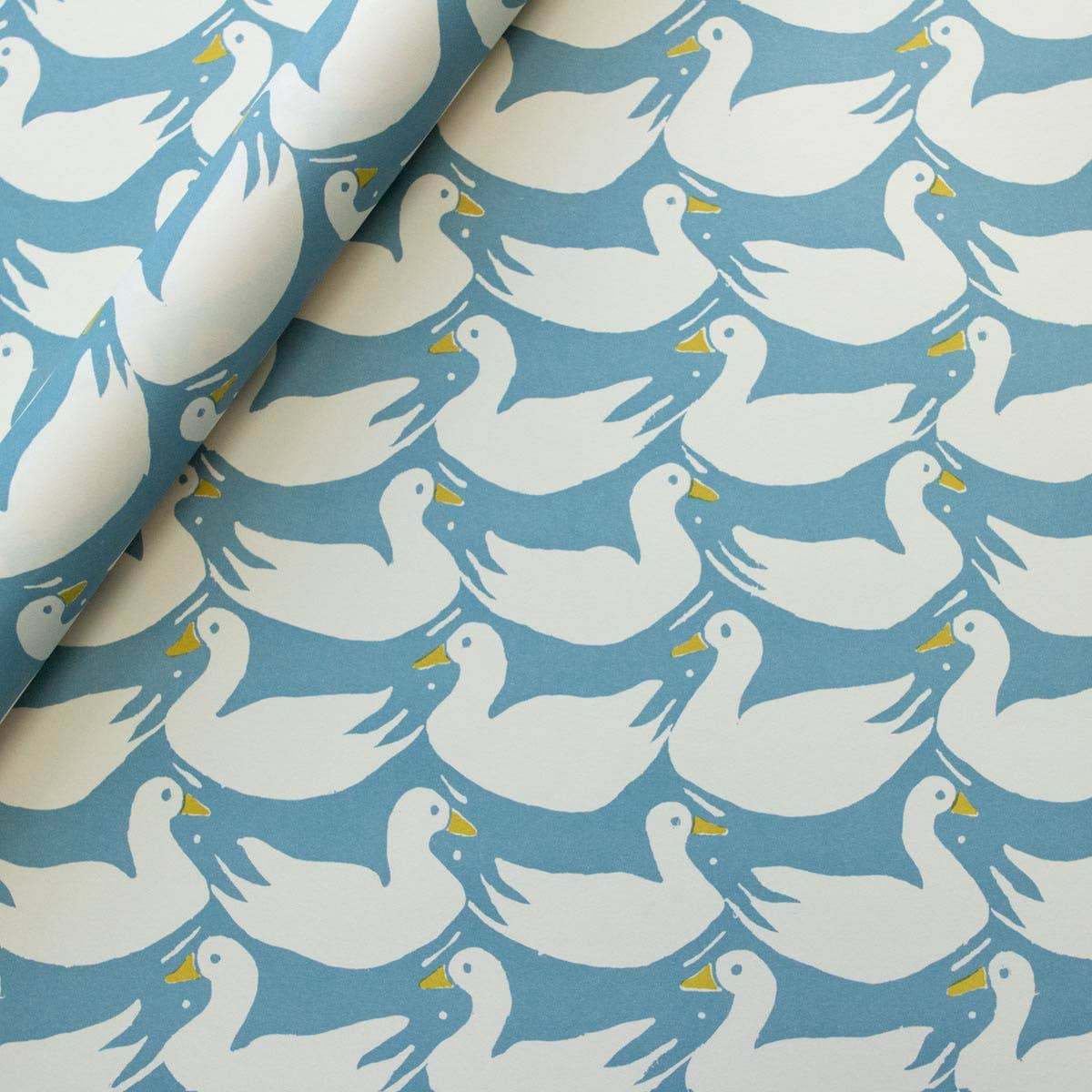 Pattern of white ducks on a blue background