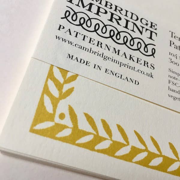Cambridge Imprint packaging with gold leaf design and text on a white background