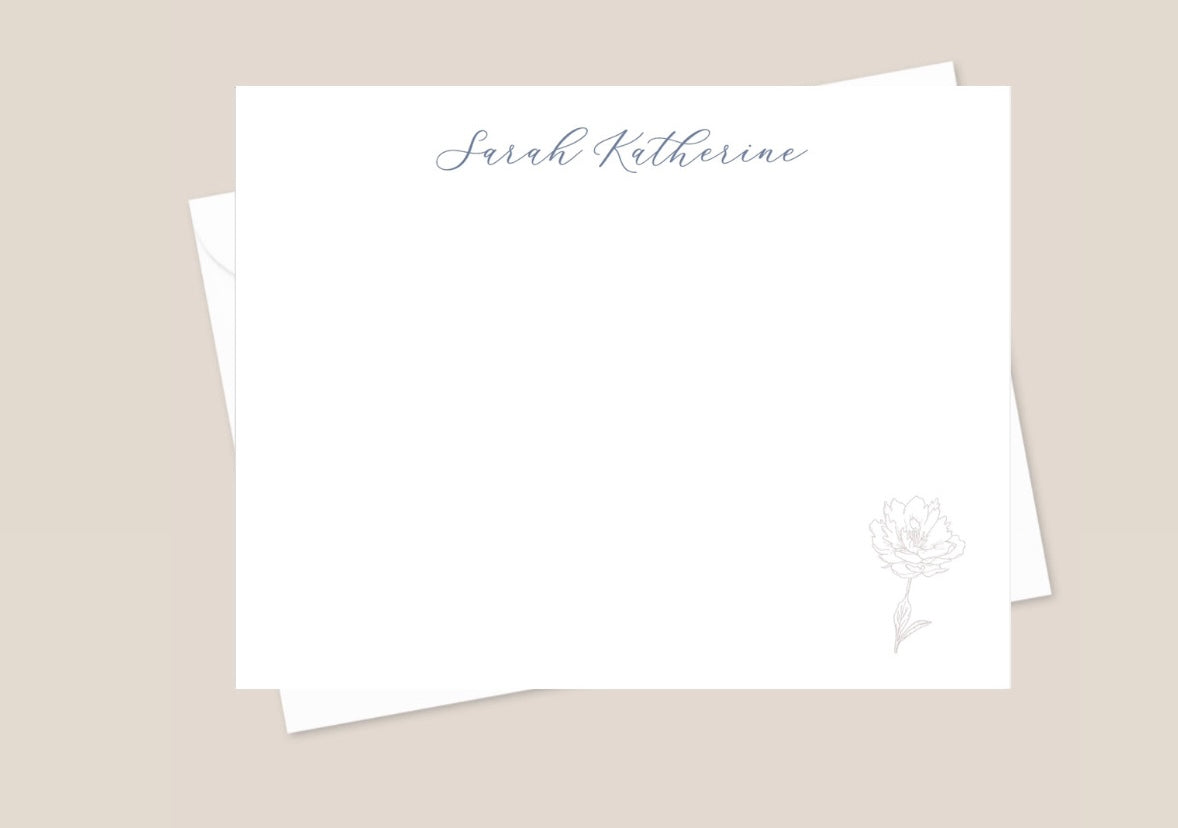 Stack of white flat note cards with a floral design and personalized name, 'Sarah Katherine', printed at the top. Cards are placed on a light background.