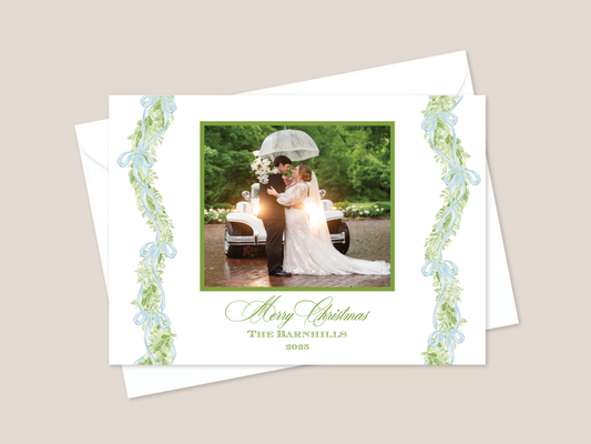 Christmas card with a photo of a couple, surrounded by decorative elements
