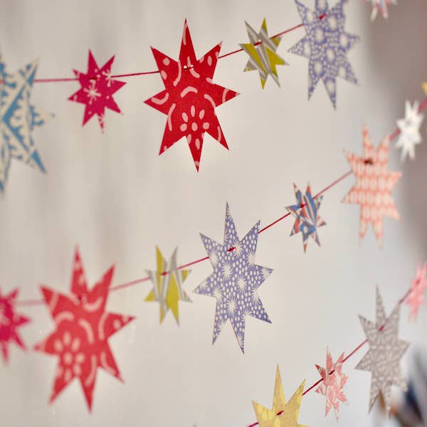 String of colorful paper stars against a neutral background