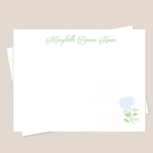 A set of white flat notecards with a small blue flower illustration and the name 'Marybelle Boone Howe' printed on the front.