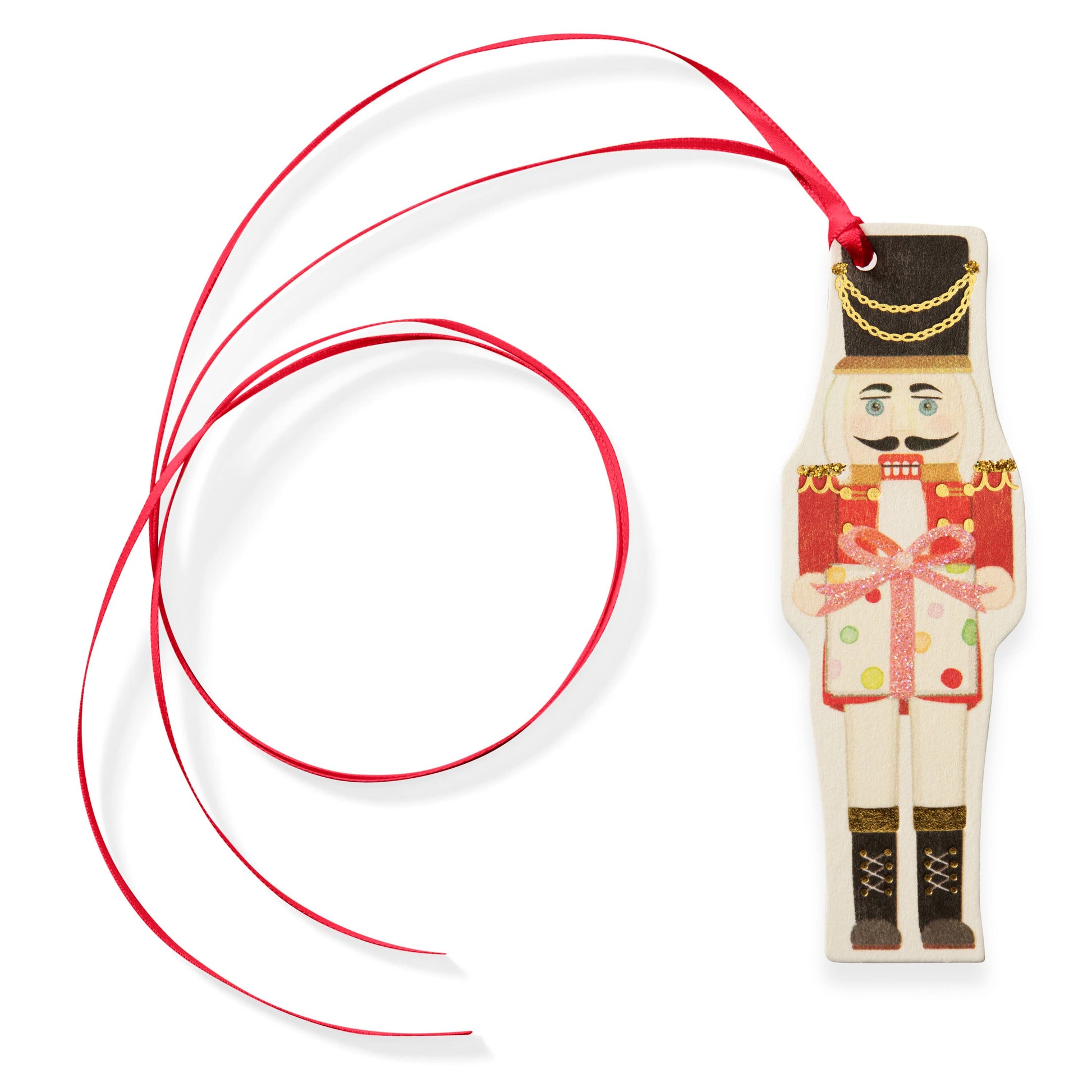 nutcracker tag ornament with a red ribbon on a white background