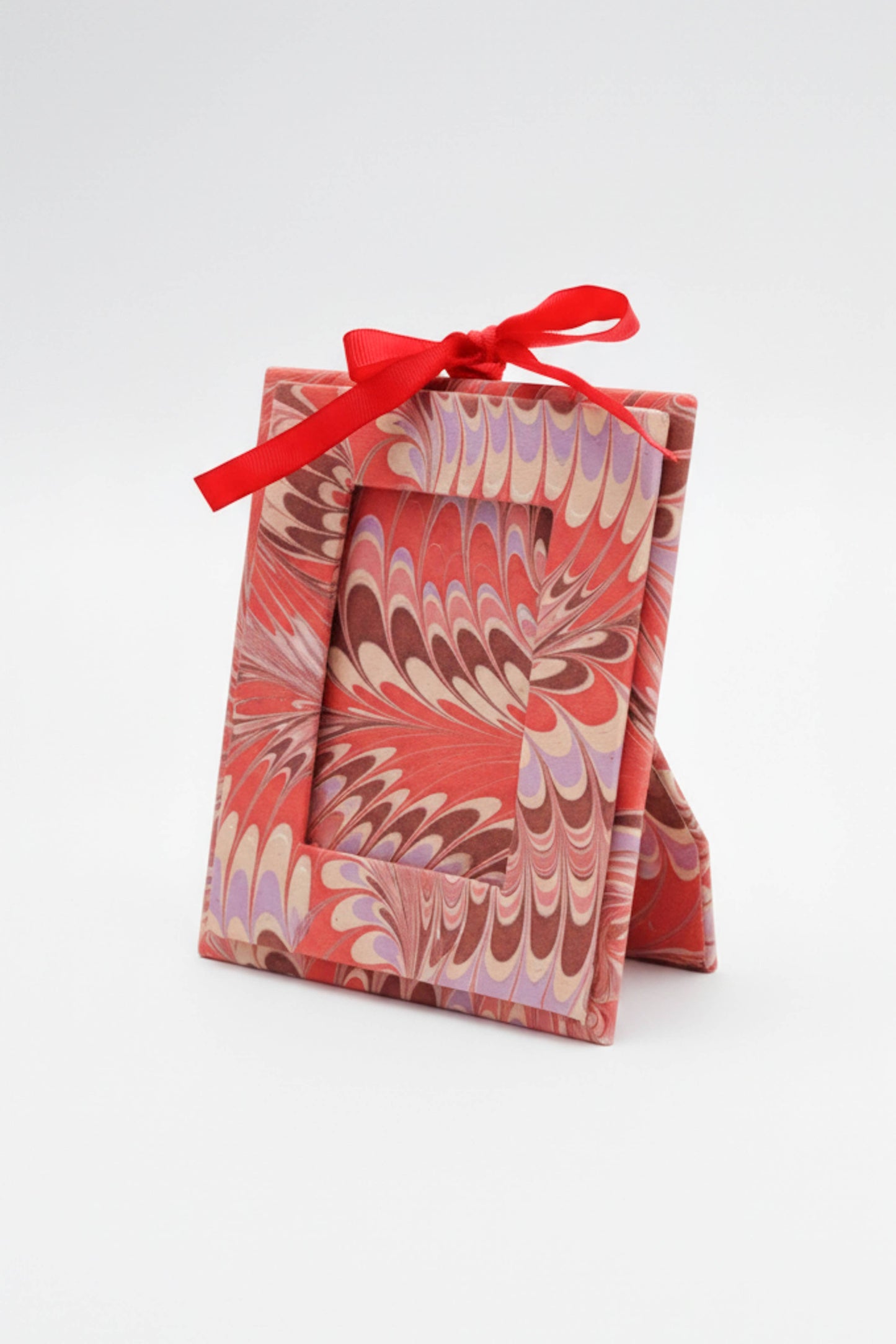 Decorative box with a red ribbon on a white background