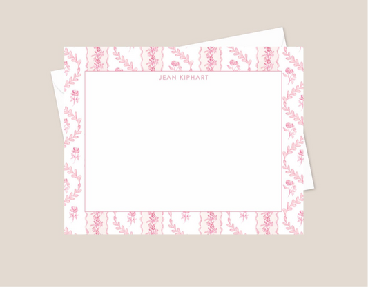 Set of stationery with floral border design on a beige background