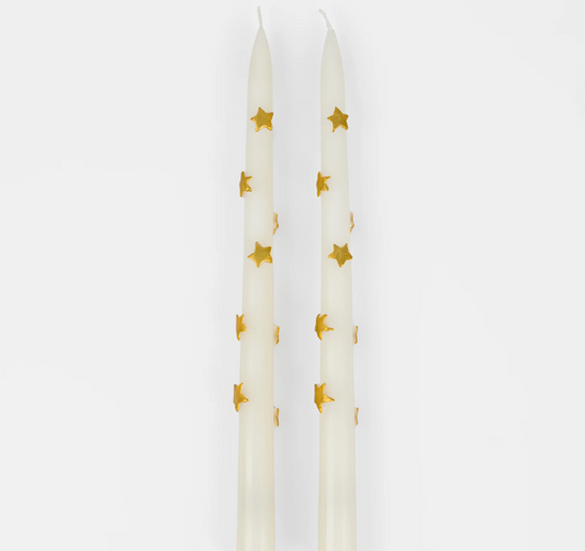 A set of two taper candles with a gold star design, displayed against a white background.