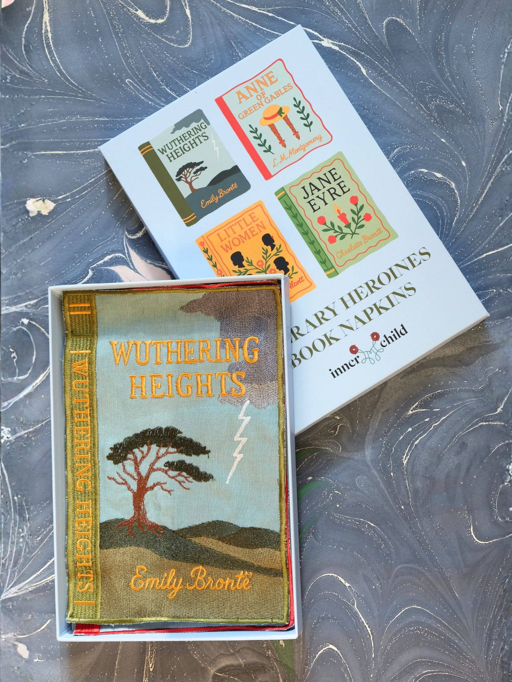 Book napkins with 'Wuthering Heights' and 'Jane Eyre' designs on a textured surface